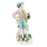 Late 18th century Derby figure of a boy holding flowers, with his dog at his feet, circa 1770,