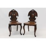 Pair of mid-Victorian carved mahogany hall chairs,