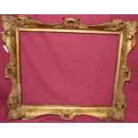 An ornate 19th century gilt and gesso frame - internal measurements 40cm x 50cm