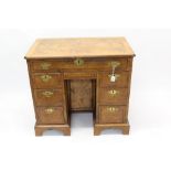 George II and later figured walnut featherbanded and crossbanded kneehole desk,