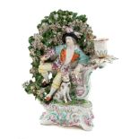 18th century Derby figure candlestick with recumbent male with bird and hound under bocage,