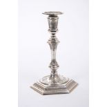 George I cast Britannia Standard silver taperstick of hexagonal form, with chased and engraved leaf,