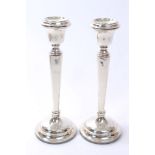 Pair contemporary silver candlesticks with octagonal tapering stems and inverted bell candle