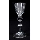 Early 18th century wine glass with conical bowl on double-knopped stem on splayed folded foot,