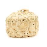 Meiji period ivory trinket box carved with thirty-three masks representing characters from the No