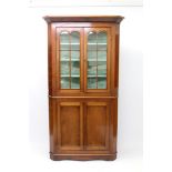 19th century mahogany standing corner cupboard with shaped shelves enclosed by pair of astragal