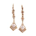 Pair diamond pendant earrings each with an articulated diamond set drop,