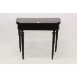 Victorian ebonised and brass inlaid card table breakfront fold-over top centred by inlaid urn and