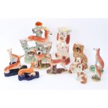 A collection of Staffordshire greyhounds and spaniels - mostly Victorian - including a pair of