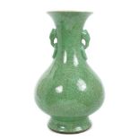 Chinese Qing period apple-green crackleglaze oviform vase with moulded elephant-head ring handles,