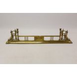 Edwardian brass fire curb with built-in fire dogs and wine bottle warmers,