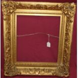 Early 19th century gilt and gesso frame with applied foliate corners - internal measurements 42cm x