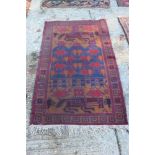 Afghan rug with human and animal forms in rustic colours in geometric borders,