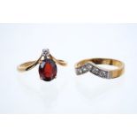 18ct gold garnet and diamond two stone ring in a wishbone design,