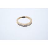 Diamond eternity ring with a half-hoop of eleven channel set brilliant cut diamonds in 14ct gold
