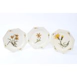 Three late 18th century octagonal creamware plates with painted yellow and green floral decoration,