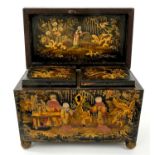 Regency black lacquered tea caddy of sarcophagus form, on ball feet,