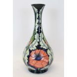 Moorcroft Pottery vase decorated in the Poppy pattern on blue ground,