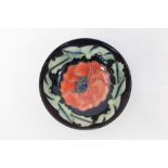 Moorcroft Pottery bowl decorated in the Poppy pattern on blue ground,