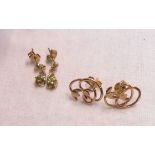 A pair of 9ct. gold peridot drop earrings - sold with a pair of marked rose metal open lily scroll
