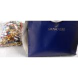 A bag containing assorted costume jewellery - sold with a quantity of Swarovski branded carrier
