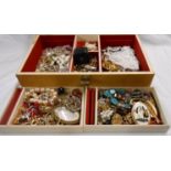 A vintage musical jewellery box containing a quantity of assorted costume jewellery