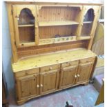 A 5' 8 1/2" Ducal two part waxed pine dresser with open shelves and flanking glazed doors to top,