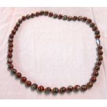 An oriental single string cloisonné bead necklace with floral decoration and original pouch