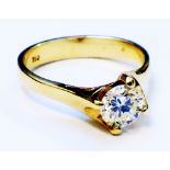 A marked 750 yellow metal 0.62ct diamond solitaire ring - with copy of the valuation certificate