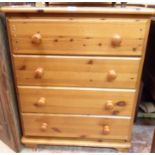 A 29" modern waxed pine chest of four long drawers (one repaired)