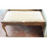 An early 20th Century stained beech framed duet piano stool with upholstered locker seat and slender