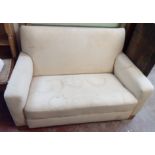 A pair of 1940's calico covered two seater utility sofas, set on simple block feet