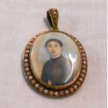 An unmarked high carat yellow metal oval pendant, set with two 38mm portrait miniatures within pearl