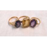 Three unmarked yellow metal dress rings, set with citrine, amethyst and alexanderite style stones