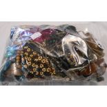 A bag containing a quantity of costume jewellery necklaces and other items