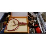A dome top jewellery casket containing a quantity of assorted boxed and loose costume jewellery,