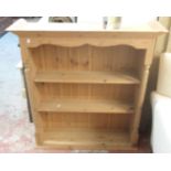 A 3' 1" stripped pine three shelf open plate rack with moulded top and flanking rope twist