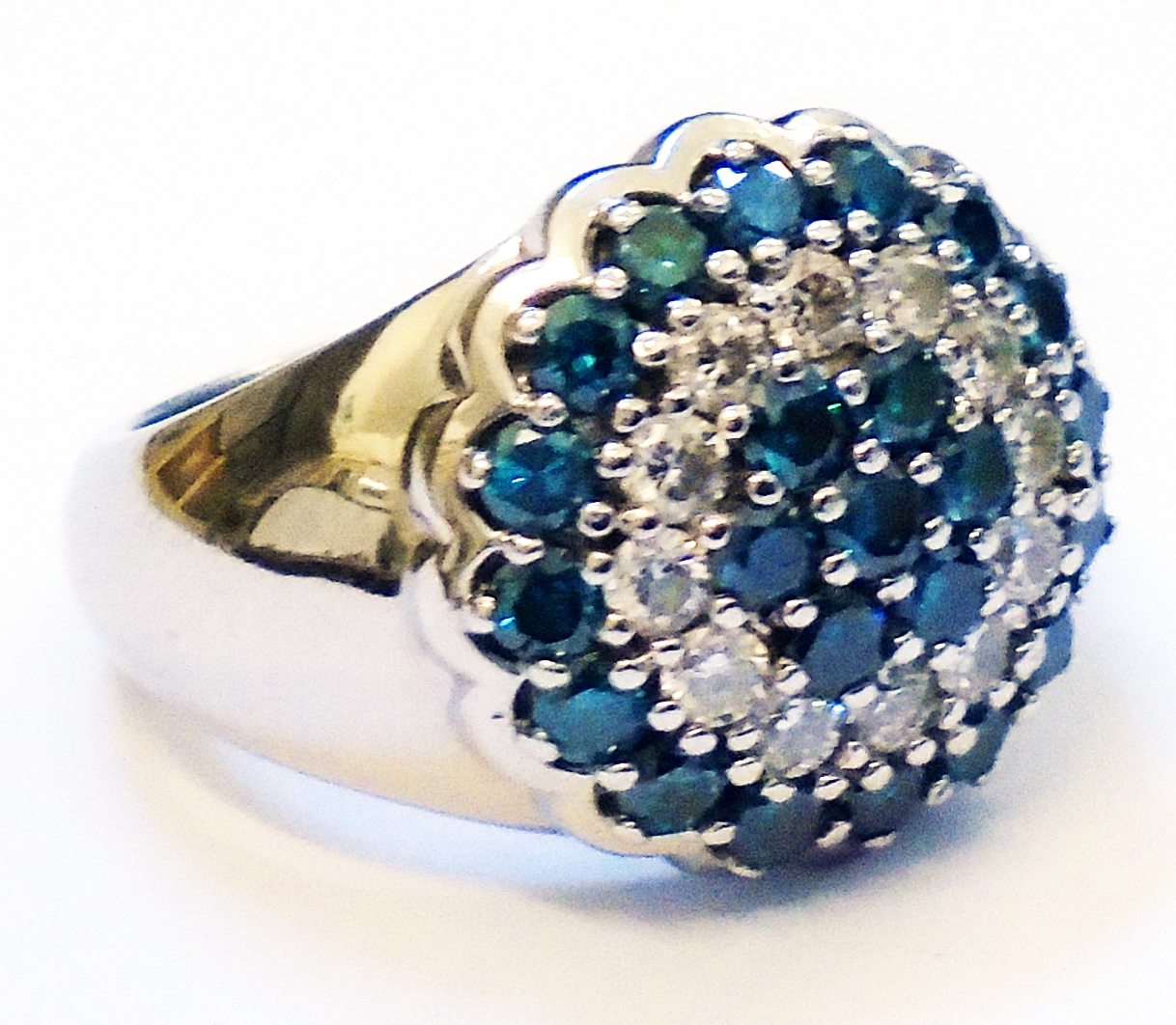 A marked 14k white metal ring, set with a blue and white diamond encrusted central panel
