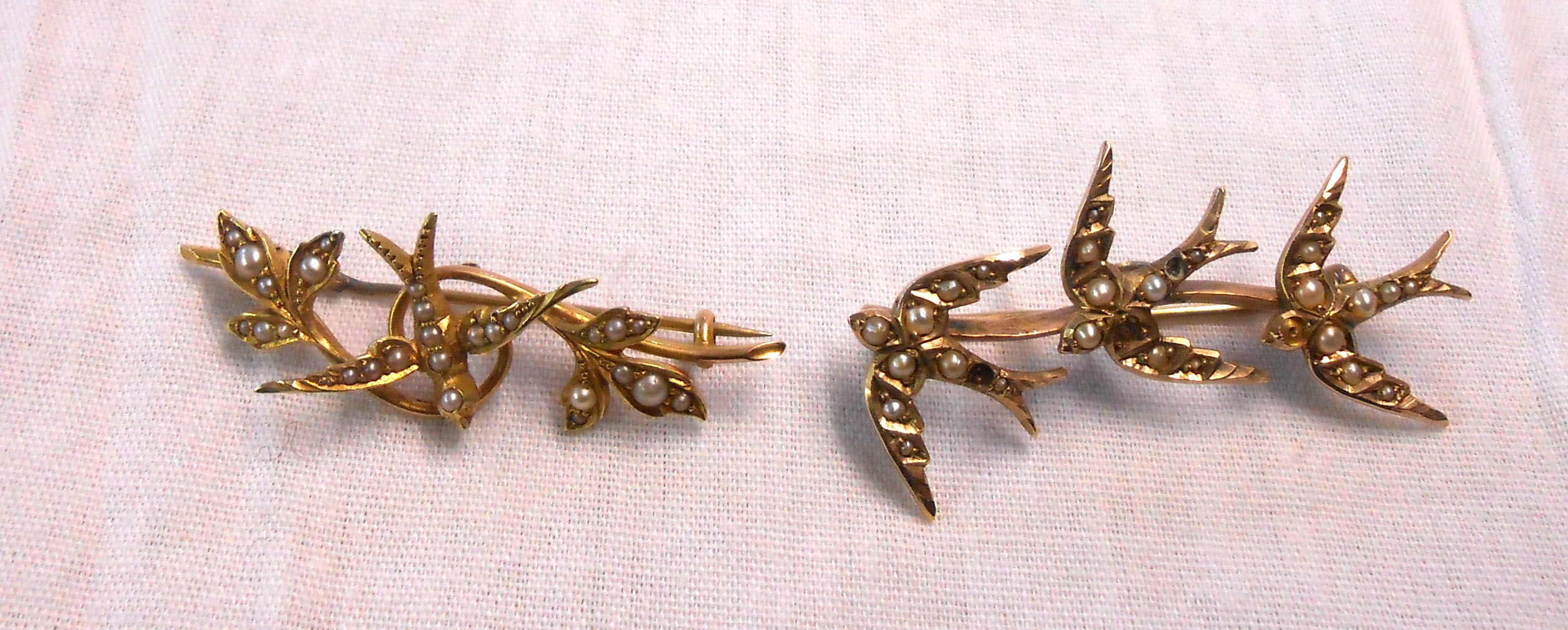 A 15ct. gold early 20th Century seed pearl encrusted swallow and branch pattern bar brooch - sold