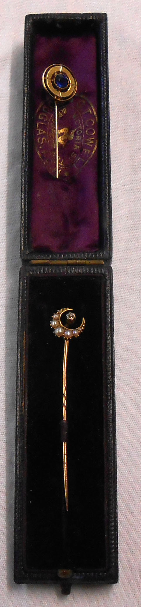 A cased 18ct. gold stick pin with rose diamond and seed pearl encrusted crescent motif - sold with