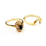 An 18ct. gold ring, set with central small marquise cornflower blue sapphire within a paved baguette