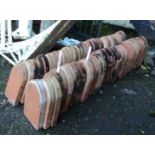 Sixty Victorian terracotta mitre shaped edging tiles