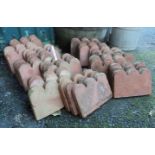 Thirty seven Victorian terracotta scallop topped edging tiles