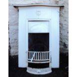 An early 20th Century painted cast iron bedroom fireplace with integral 23" mantelpiece