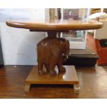 A 28" retro teak oval topped tea table with carved elephant pattern support