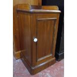 A Victorian mahogany pot cupboard with gallery to top, rounded corners and panelled door