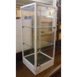 A 31 1/2" high modern white painted metal framed and glazed table top display cabinet with locking
