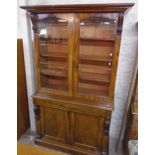 A 4' Victorian mahogany two part book cabinet with moulded cornice, flanking scroll capitals and