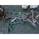 A cast iron table end with green painted finish - sold with another similar