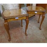 A pair of reproduction figured walnut and cross banded side tables with glass inset tops, moulded